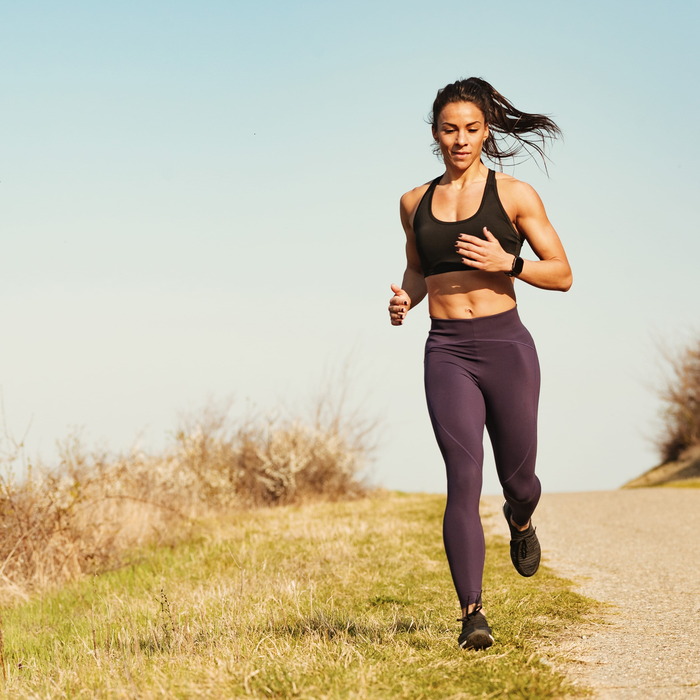 full_length_determined_female_athlete_running_while_exercising_nature_copy_space-mSYZDfis